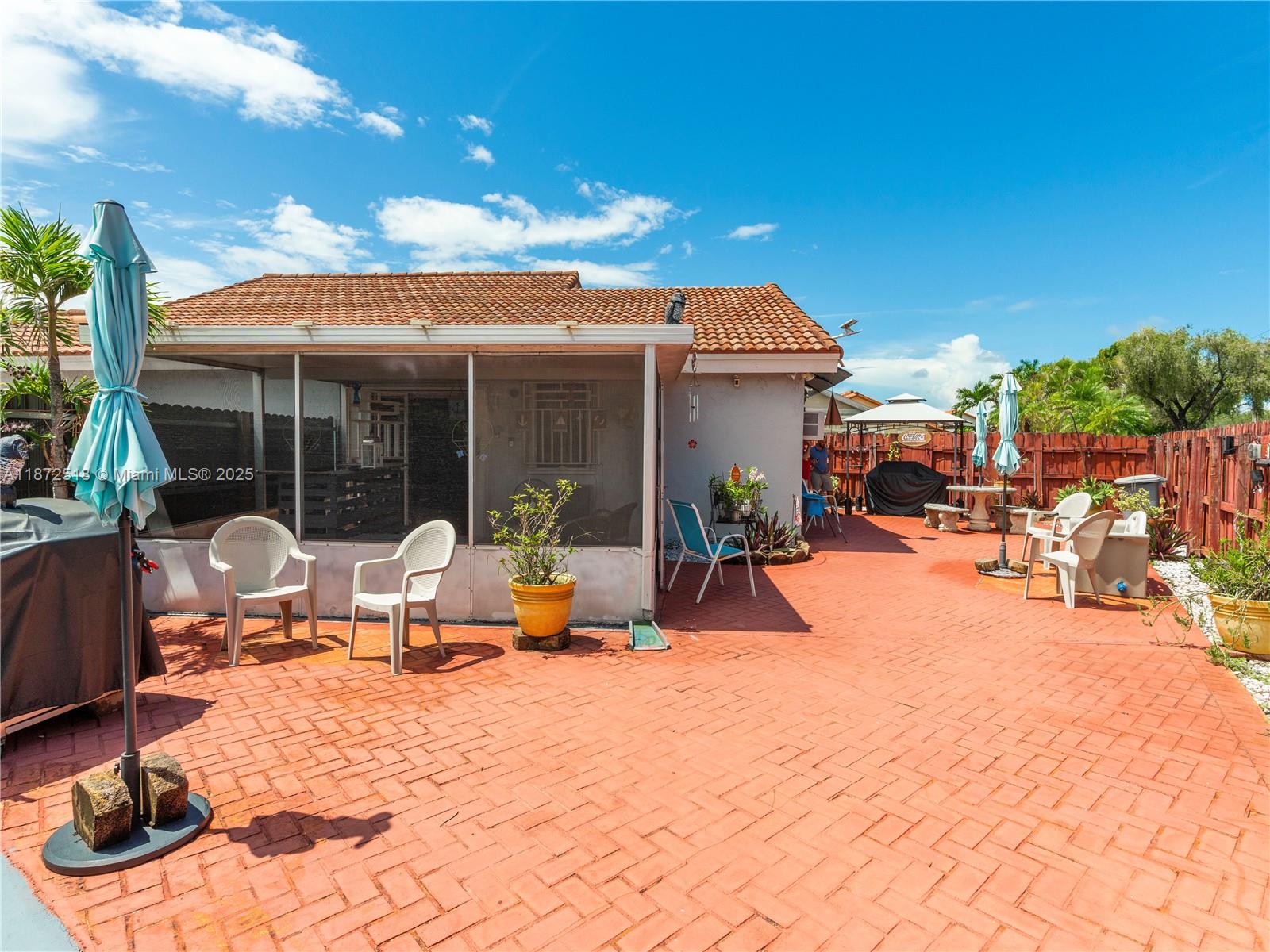 15275 Southwest 56th Terrace Miami, FL 33193 - Photo 21 of 32 a view of a patio with swimming pool table and chairs