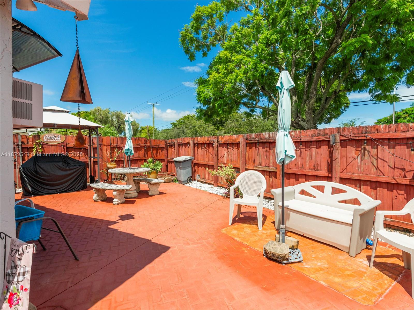 15275 Southwest 56th Terrace Miami, FL 33193 - Photo 22 of 32 a outdoor space with chairs a table and chairs
