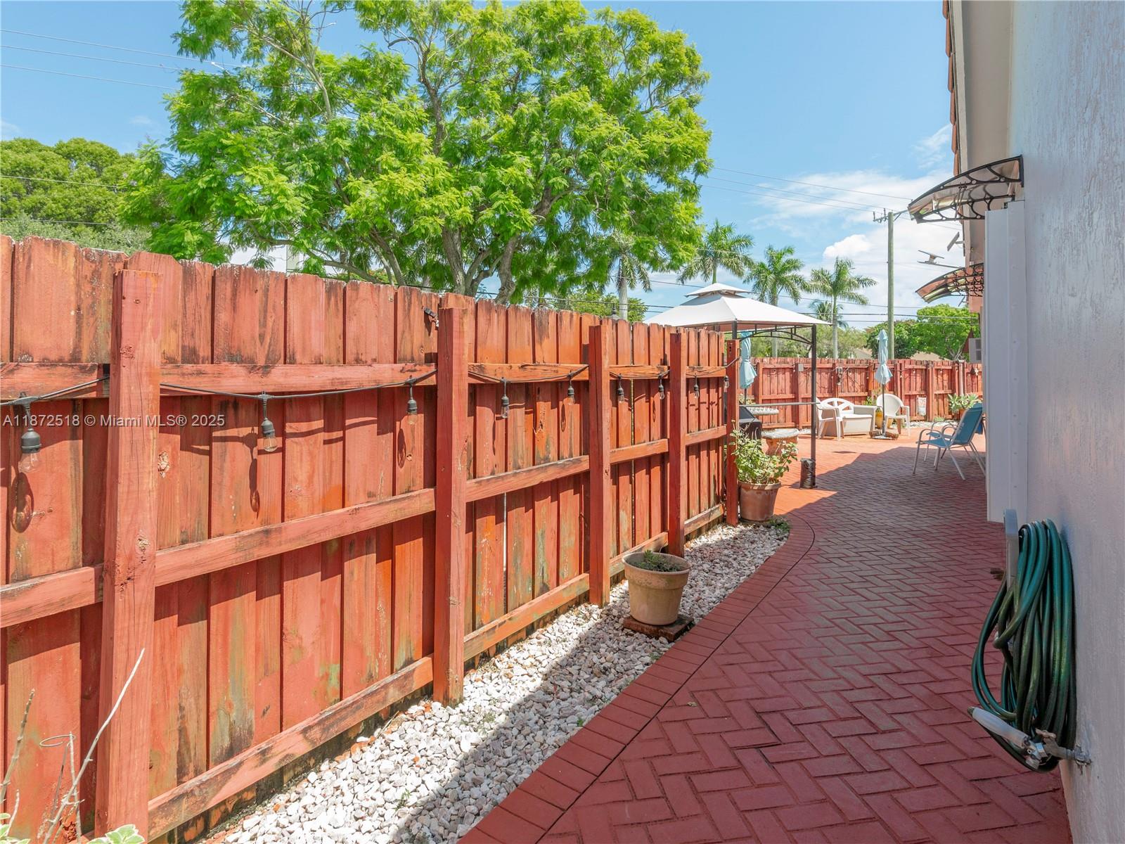 15275 Southwest 56th Terrace Miami, FL 33193 - Photo 24 of 32 a view of a house with backyard and wooden fence