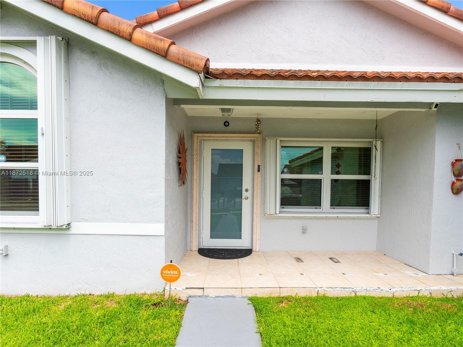15275 Southwest 56th Terrace Miami, FL 33193 - Photo 3 of 32 a front view of a house with a yard