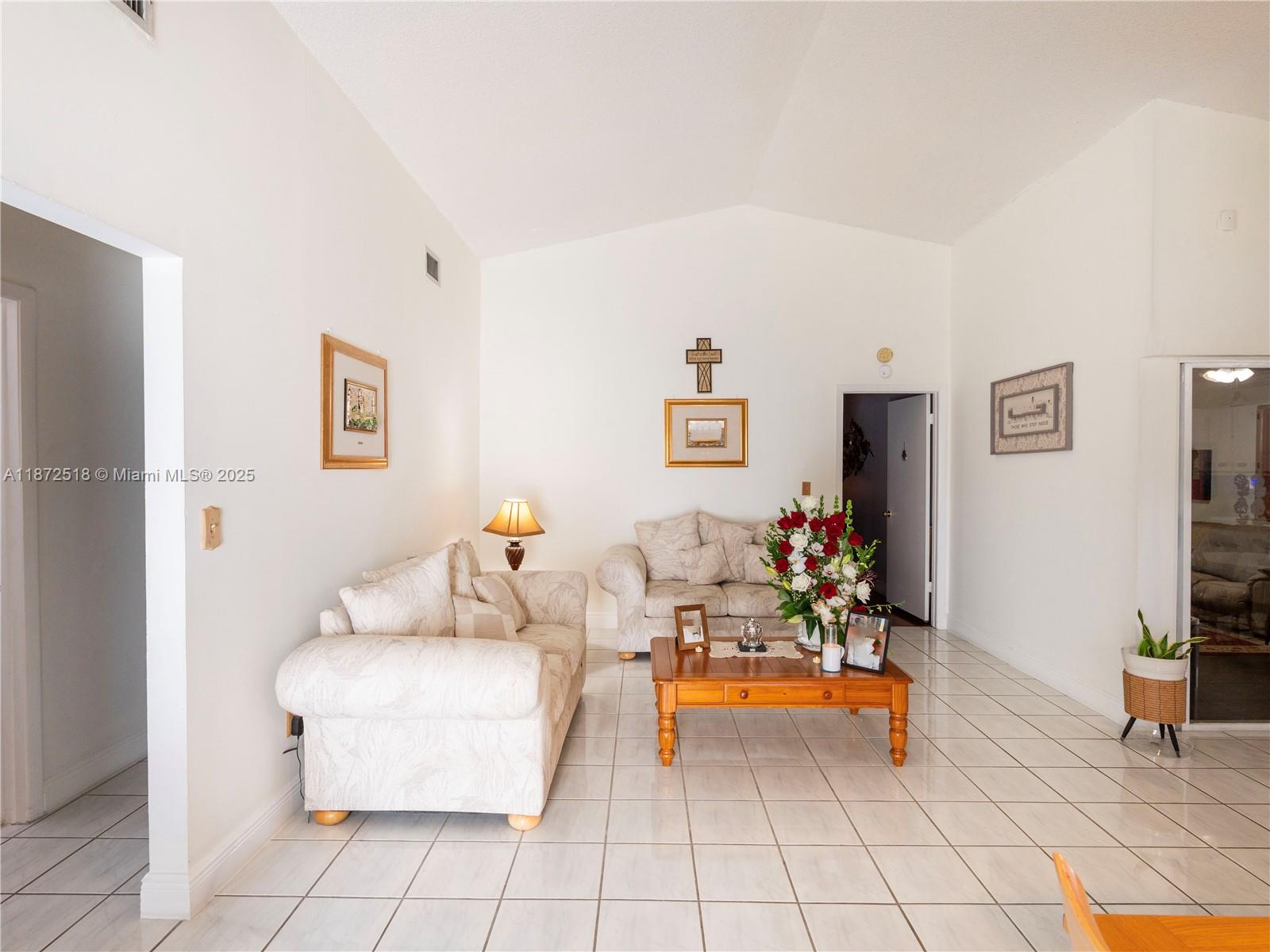15275 Southwest 56th Terrace Miami, FL 33193 - Photo 4 of 32 a living room with furniture and a flat screen tv