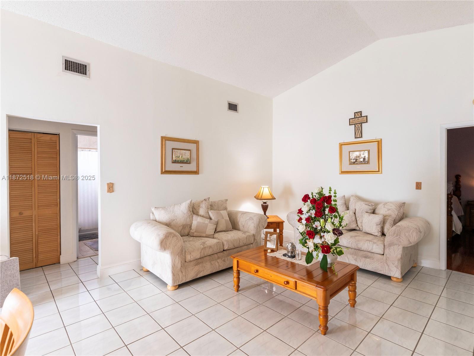 15275 Southwest 56th Terrace Miami, FL 33193 - Photo 5 of 32 a living room with furniture and a couch