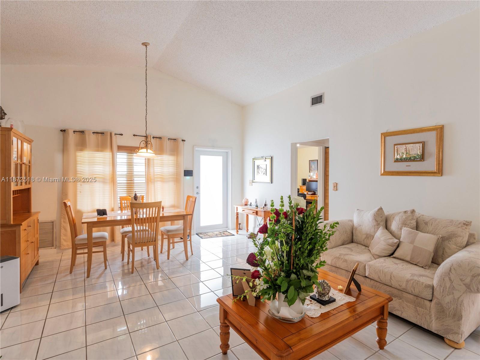 15275 Southwest 56th Terrace Miami, FL 33193 - Photo 6 of 32 a living room with furniture kitchen view and a chandelier