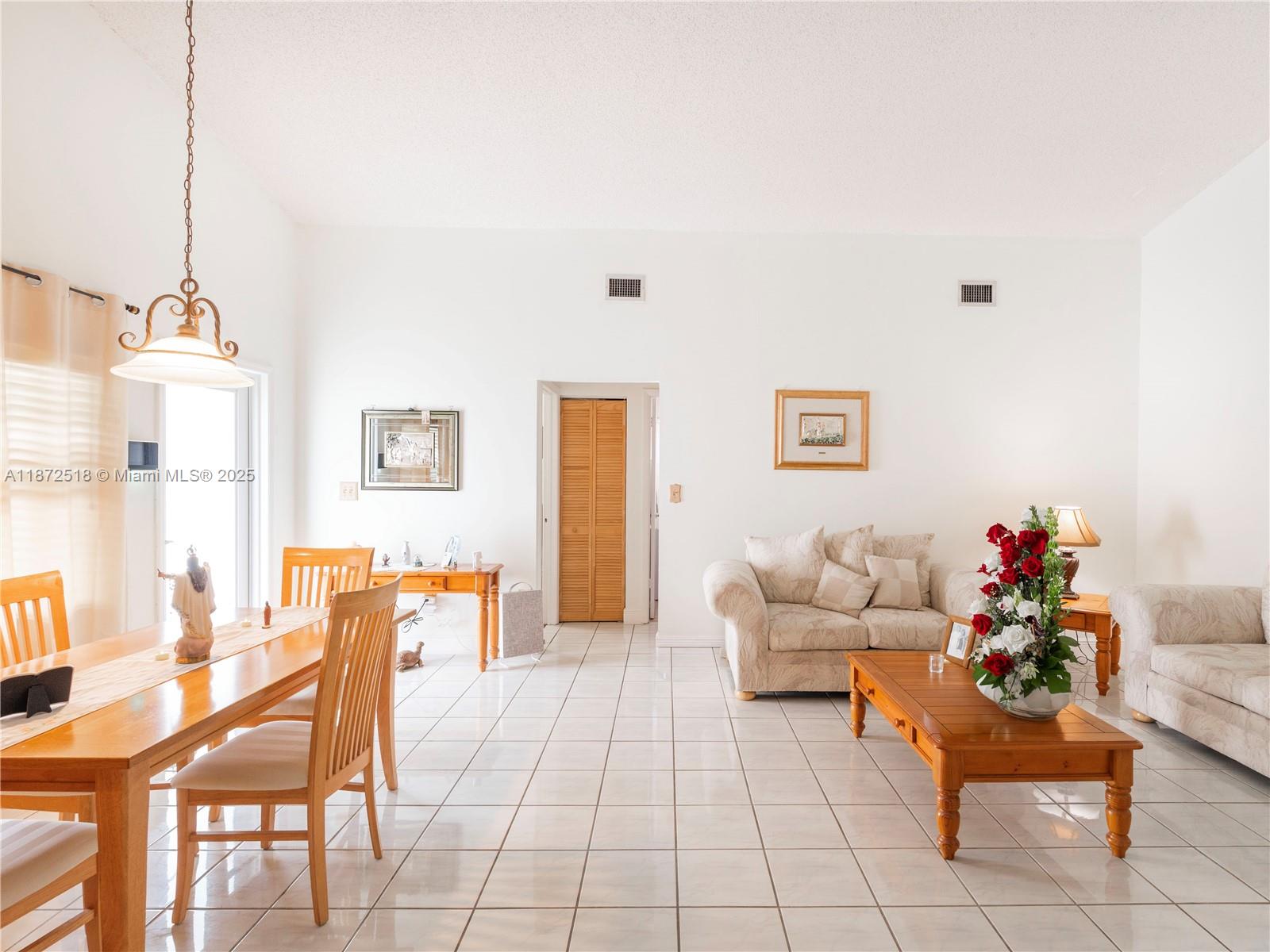15275 Southwest 56th Terrace Miami, FL 33193 - Photo 7 of 32 a living room with furniture and a table