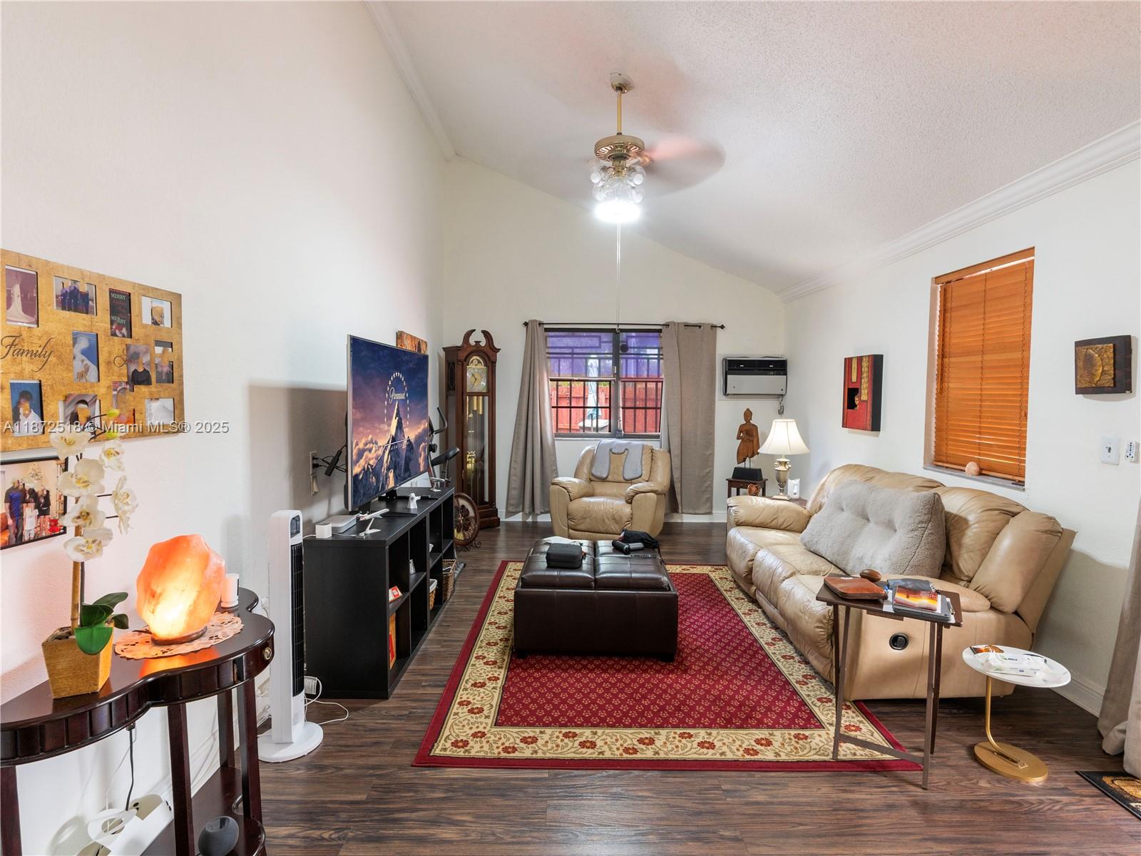 15275 Southwest 56th Terrace Miami, FL 33193 - Photo 10 of 32 a living room with furniture gym equipment and a flat screen tv