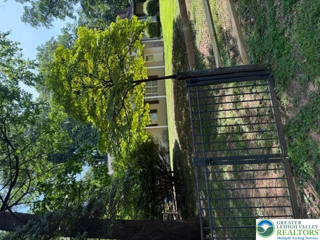 2045 Church Road Bethlehem, PA 18015 - Photo 3 of 42 Mature trees and a robust fence enclose this property, offering both natural beauty and security.