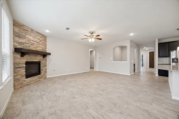 a view of an empty room with a fireplace