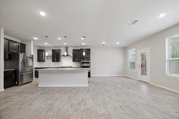 a large kitchen with stainless steel appliances kitchen island a large counter top and a sink