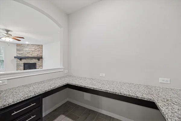 a kitchen with granite countertop white cabinets and a dishwasher