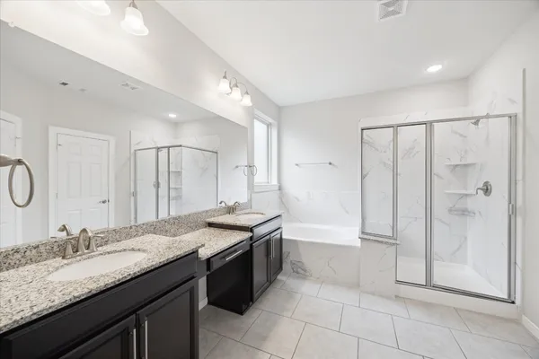 a bathroom with a granite countertop sink mirror and shower