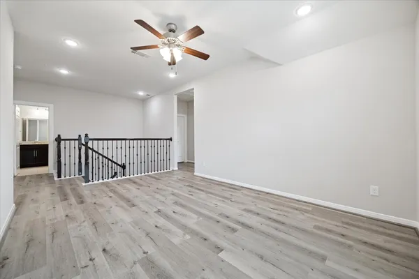 a view of a hallway with wooden floor