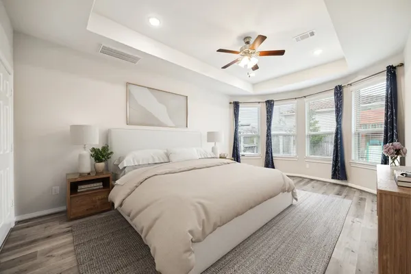 a spacious bedroom with a large bed and a large window