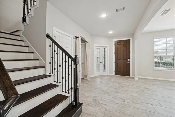 a view of entryway with wooden floor and stairs