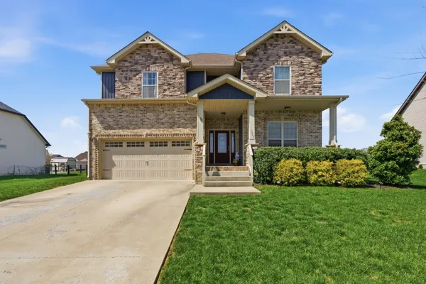 a front view of a house with a yard and garage