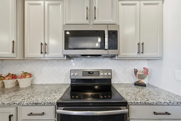 a stove top oven sitting inside of a kitchen