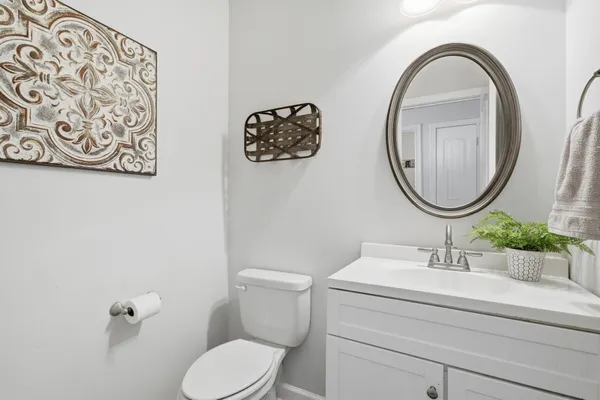 a bathroom with a toilet a sink and a mirror