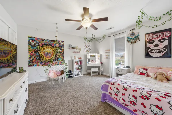 a bedroom with furniture and a chandelier