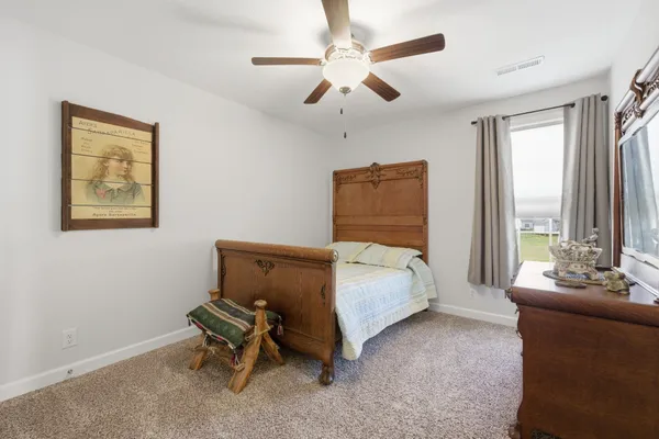 a bedroom with a bed and a couch