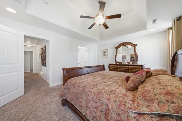 a bedroom with a bed and a chandelier