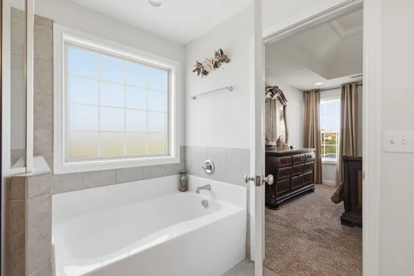 a bathroom with a bathtub and a shower