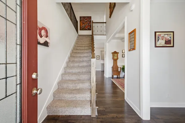 a view of an entryway with wooden floor and a hallway