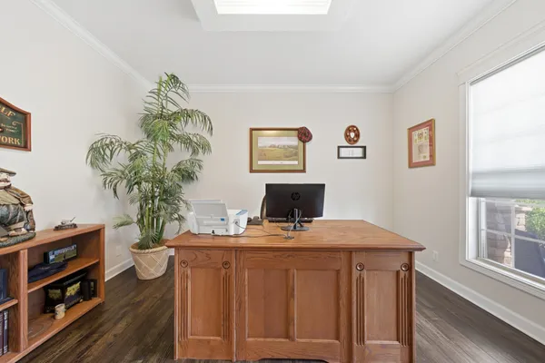 a view of a workspace with furniture and wooden floor