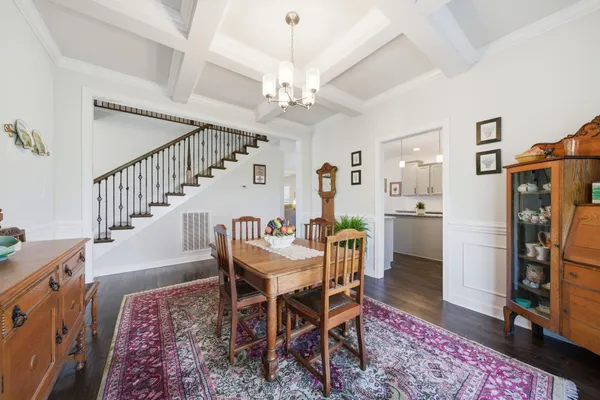 a view of a dining room with furniture and a chandelier