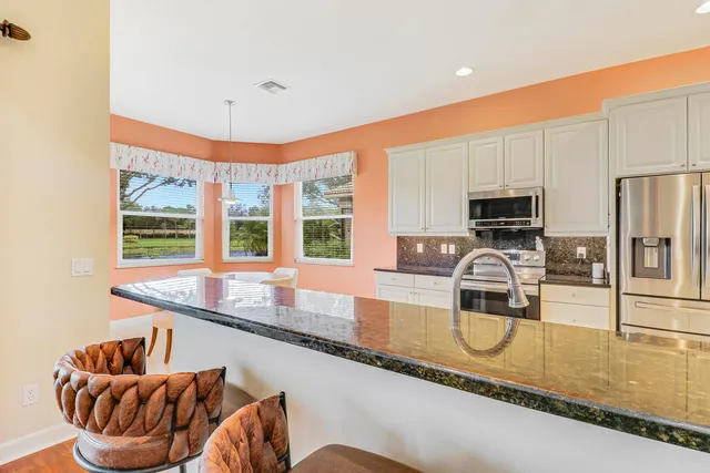 a kitchen with granite countertop a sink and a counter top space