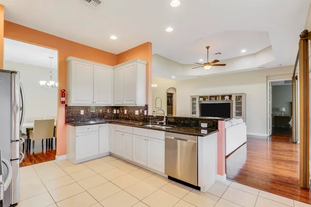 a kitchen with stainless steel appliances granite countertop a stove and a sink