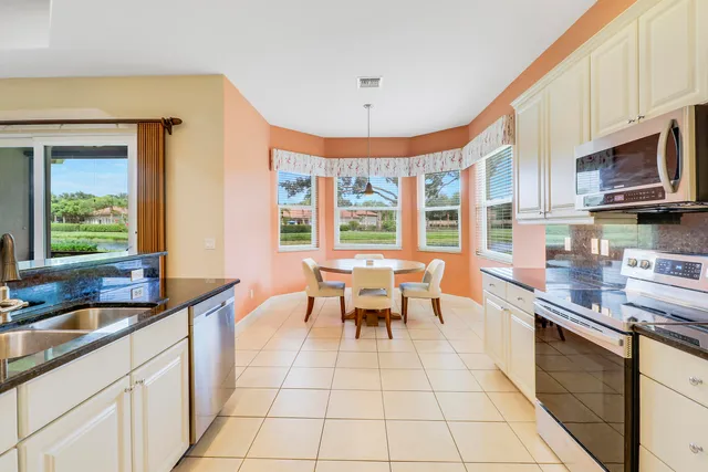 a kitchen with stainless steel appliances granite countertop a sink and cabinets