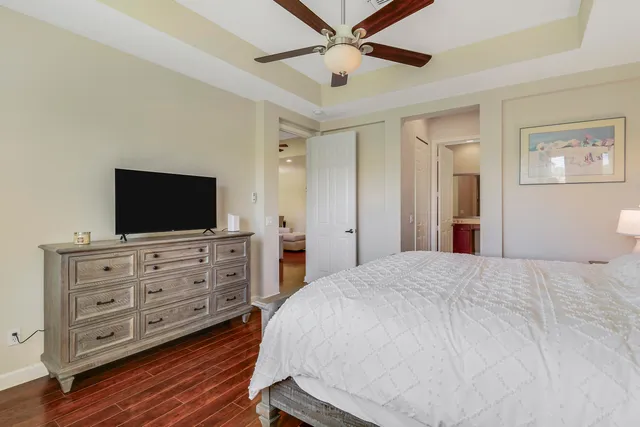 a bedroom with a bed and flat screen tv