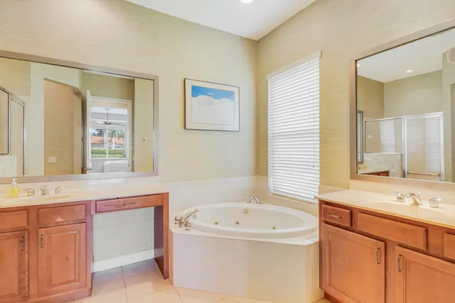 a bathroom with a bathtub sink and mirror
