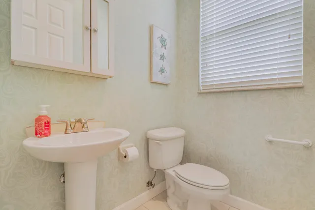 a bathroom with a sink a toilet and mirror