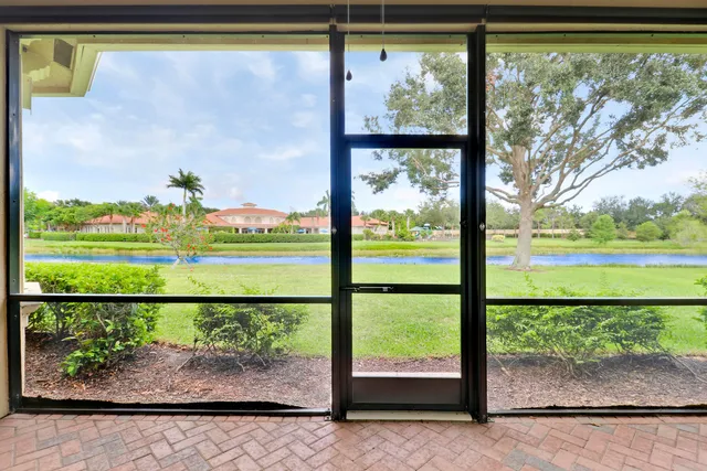 a view of a garden and lake from a window