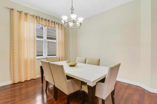 a view of a dining room with furniture wooden floor and chandelier