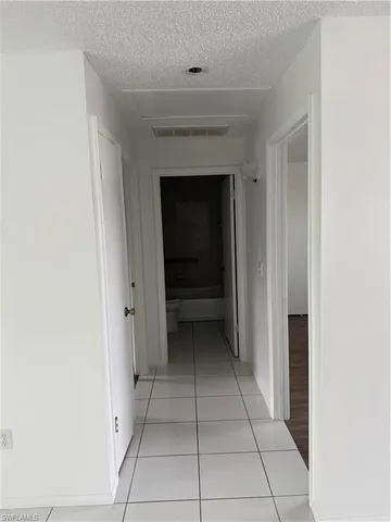 a view of an empty room with a fireplace