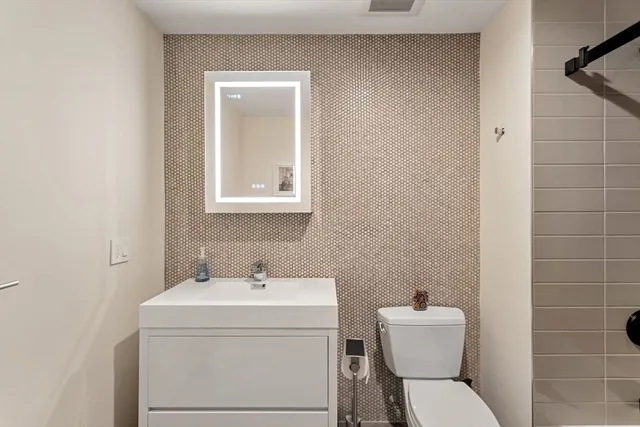 a bathroom with a sink toilet and vanity