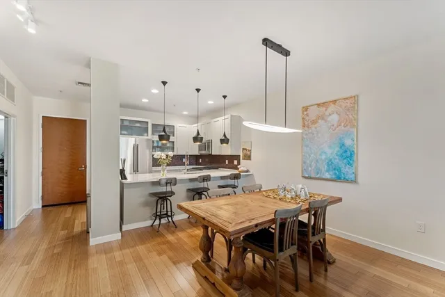 a view of a dining room with furniture and wooden floor