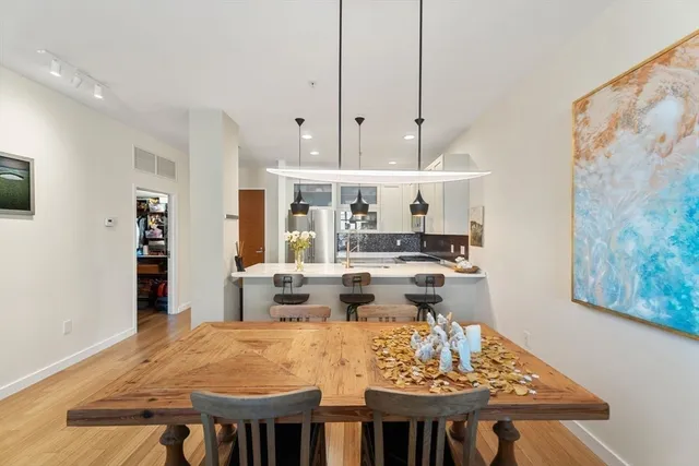 a large kitchen with a table and chairs
