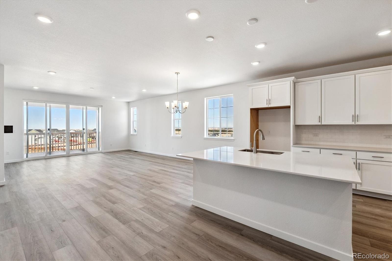 741 Lawson Drive Elizabeth, CO 80107 - Photo 12 of 27 a large kitchen with stainless steel appliances a large counter top a stove and a refrigerator