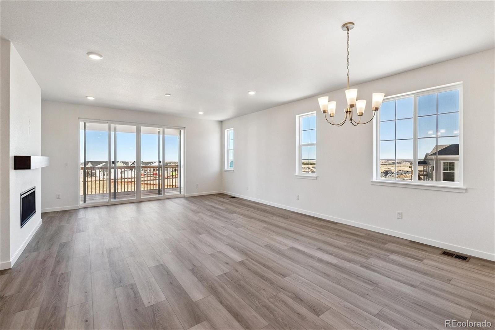 741 Lawson Drive Elizabeth, CO 80107 - Photo 13 of 27 a view of an empty room with a window and wooden floor