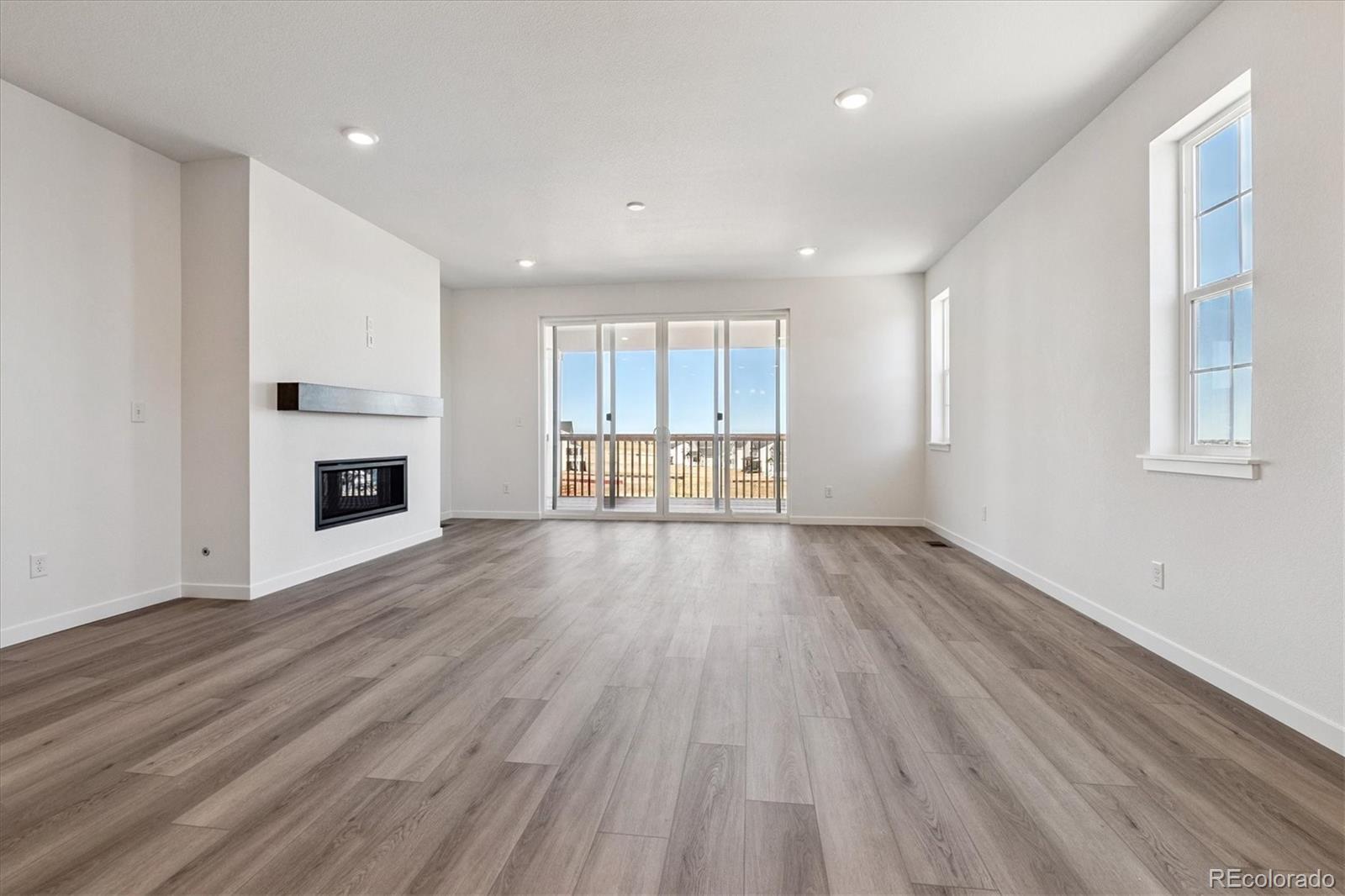 741 Lawson Drive Elizabeth, CO 80107 - Photo 15 of 27 a view of a room with wooden floors and fireplace
