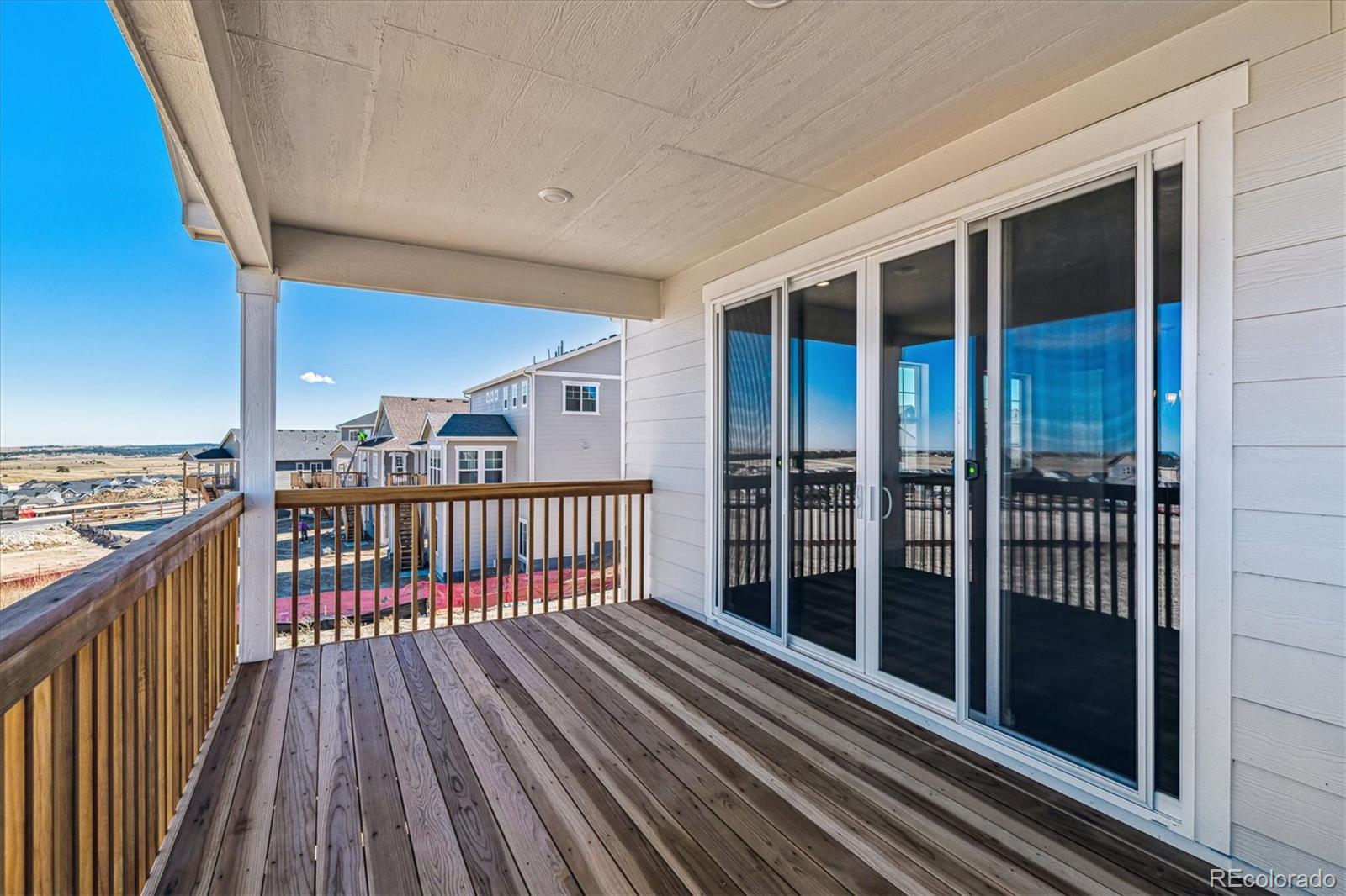 741 Lawson Drive Elizabeth, CO 80107 - Photo 24 of 27 a view of balcony with wooden floor