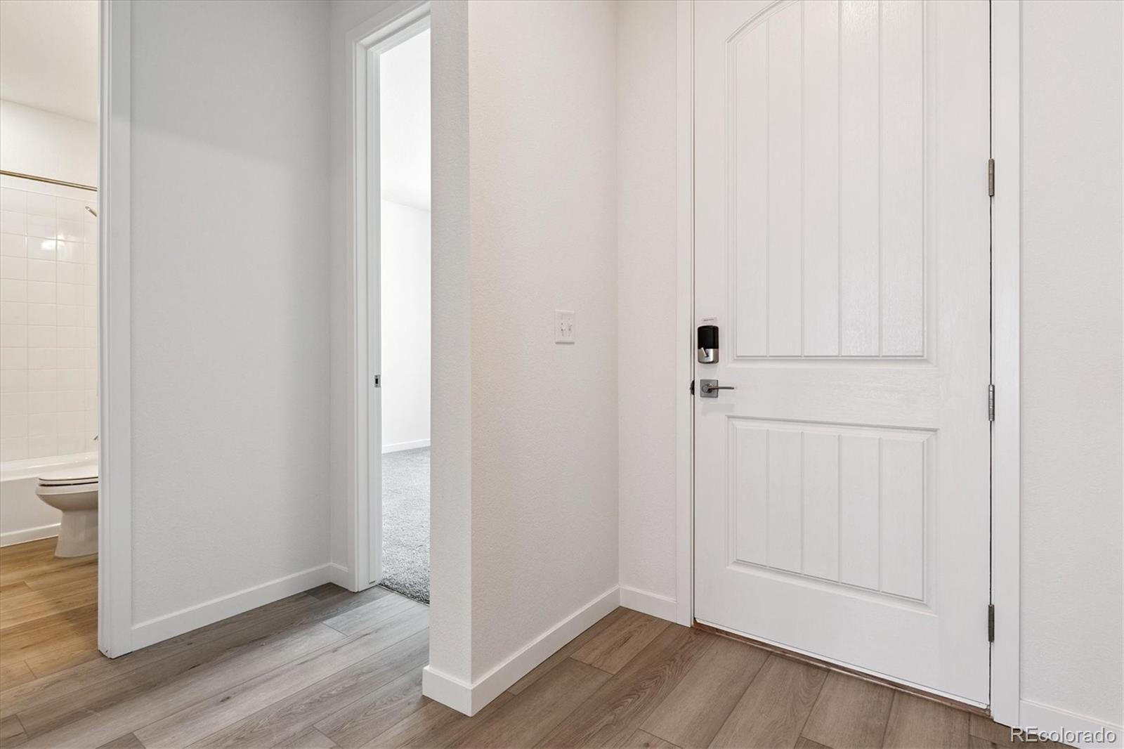 741 Lawson Drive Elizabeth, CO 80107 - Photo 3 of 27 an empty room with wooden floor and closet