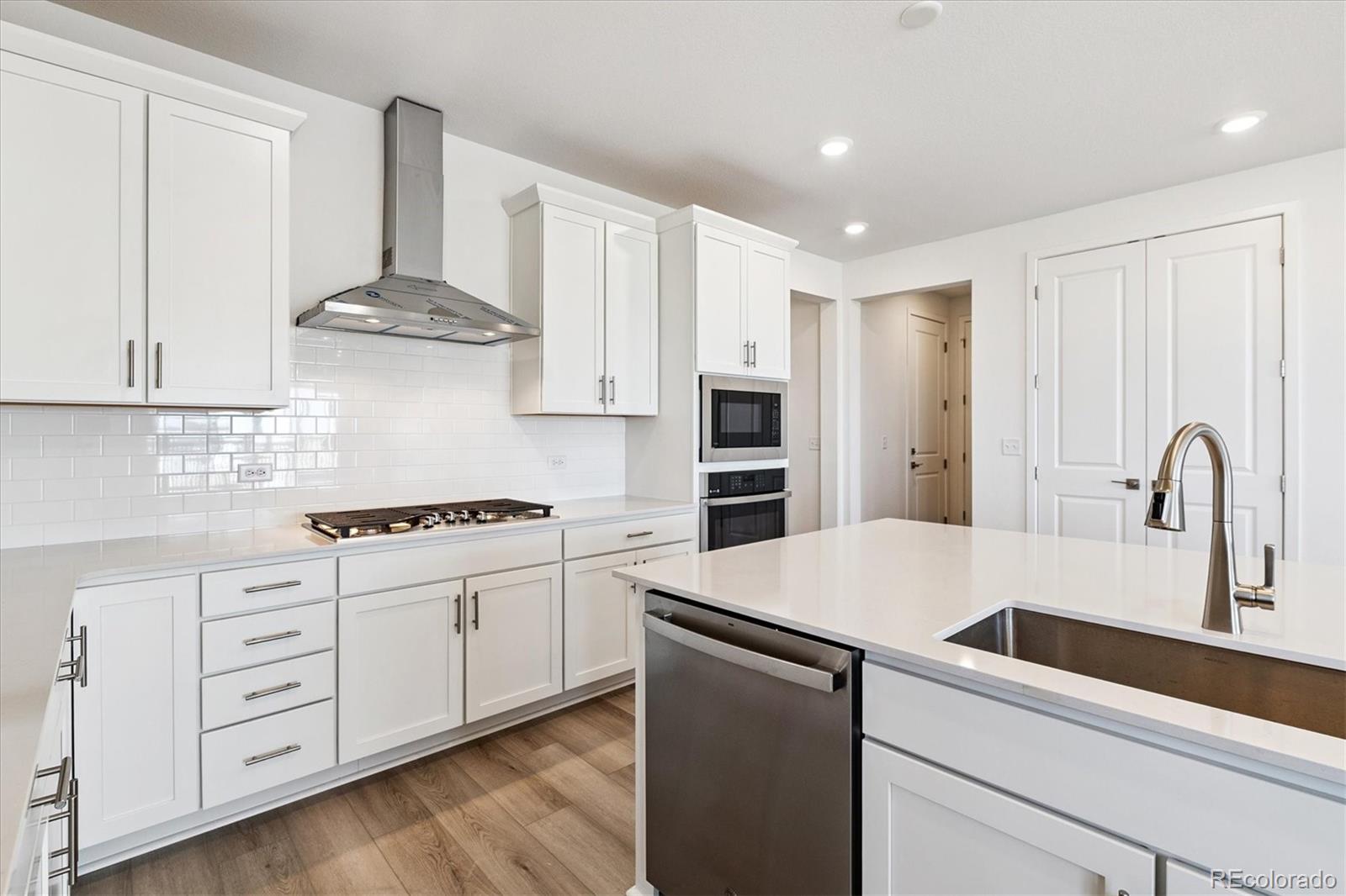 741 Lawson Drive Elizabeth, CO 80107 - Photo 10 of 27 a kitchen with white cabinets and appliances