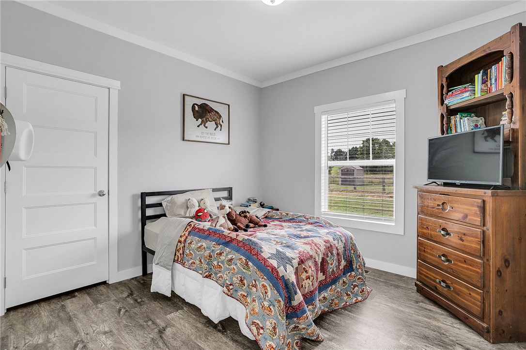 615 Wilson Road Central, SC 29630 - Photo 17 of 50 Smooth wood-plank flooring and a tall window bring warmth and light to this bedroom.