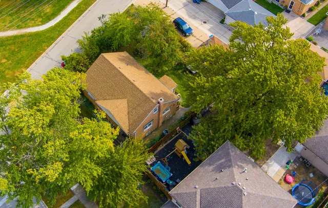 aerial view of a house with a yard and plants