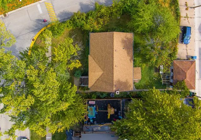 an aerial view of a house with a yard