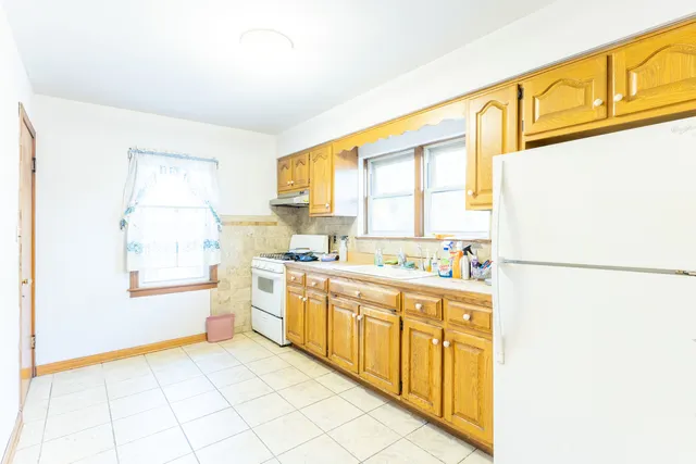 a kitchen with stainless steel appliances a refrigerator sink and cabinets