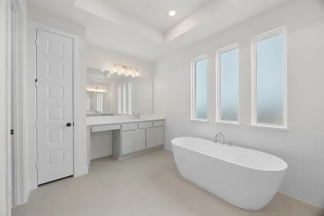 a spacious bathroom with a bathtub and shower